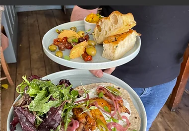Freshly prepared plates carried through The Pelham Arms dining room